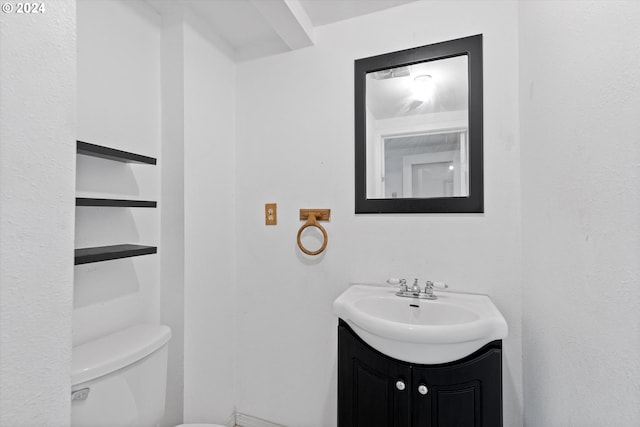 bathroom with toilet and vanity