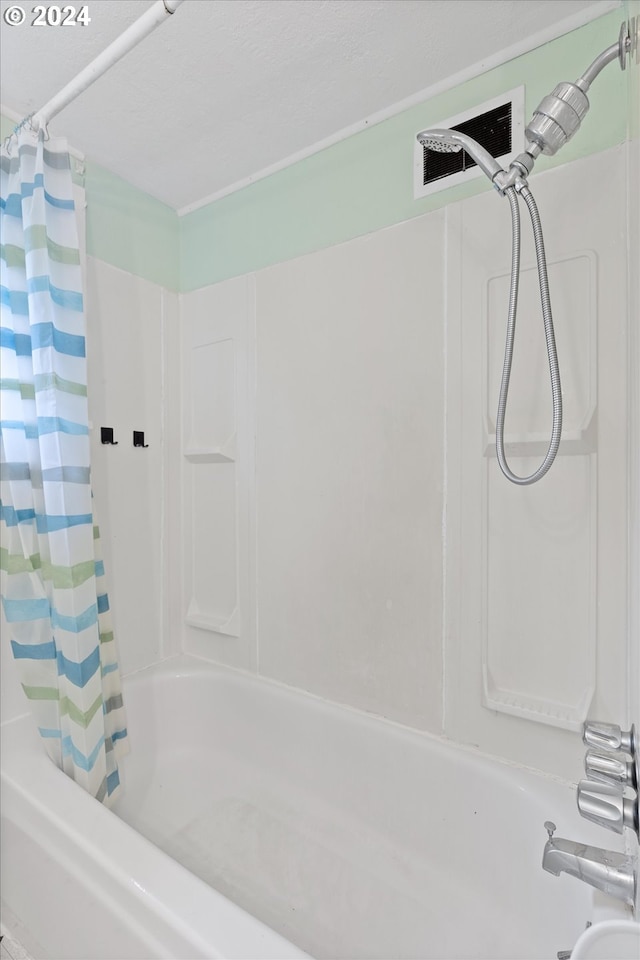 bathroom featuring shower / tub combo with curtain