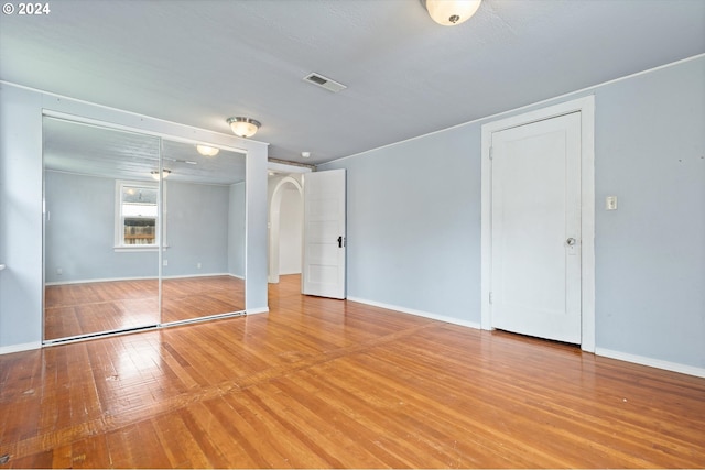 unfurnished bedroom with hardwood / wood-style flooring