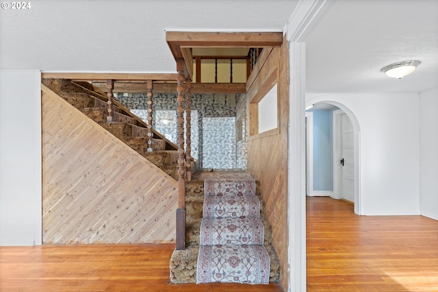 stairs with hardwood / wood-style flooring