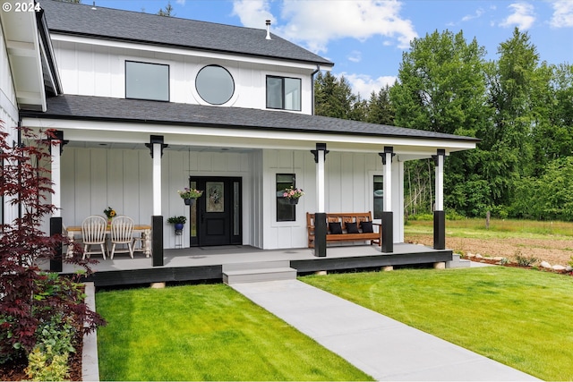 view of front of home with a front yard and a porch