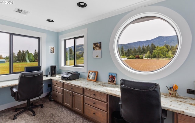 carpeted office featuring a mountain view and crown molding