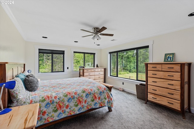 carpeted bedroom with ceiling fan and ornamental molding