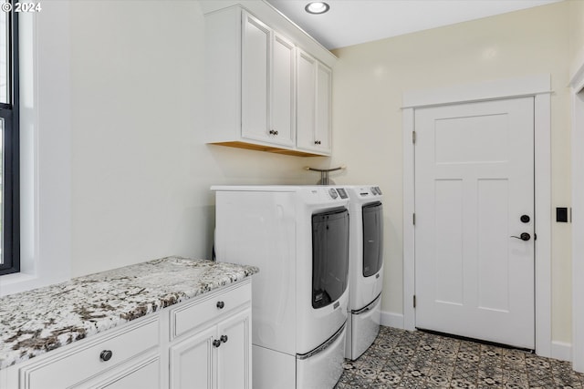 washroom with washer and clothes dryer and cabinets