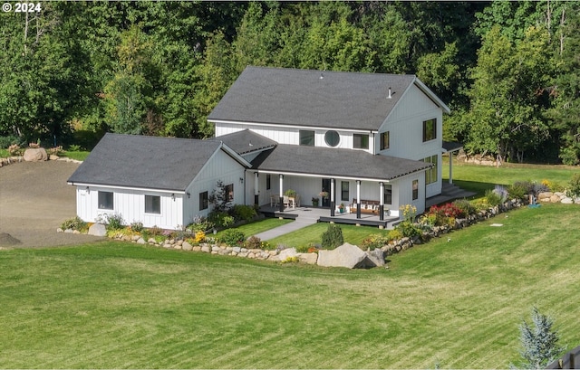 back of house with a lawn and an outdoor hangout area