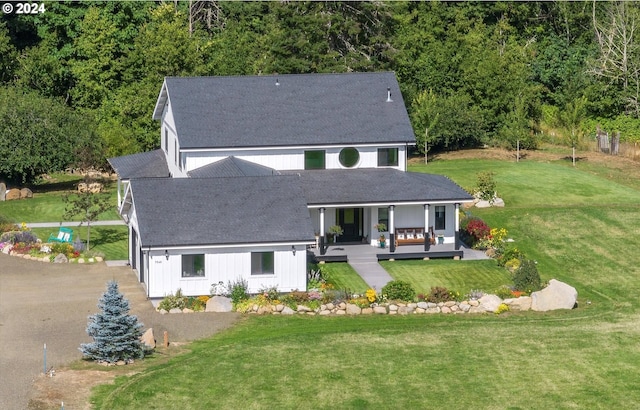 rear view of property featuring an outdoor living space and a yard