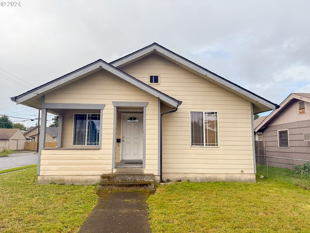 bungalow-style house with a front yard