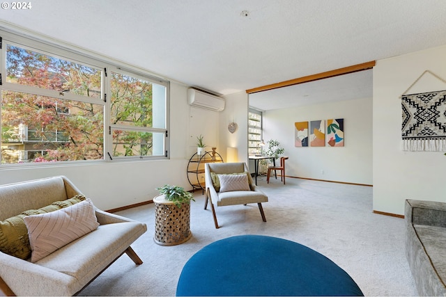 sitting room with a textured ceiling, a wall unit AC, and carpet flooring