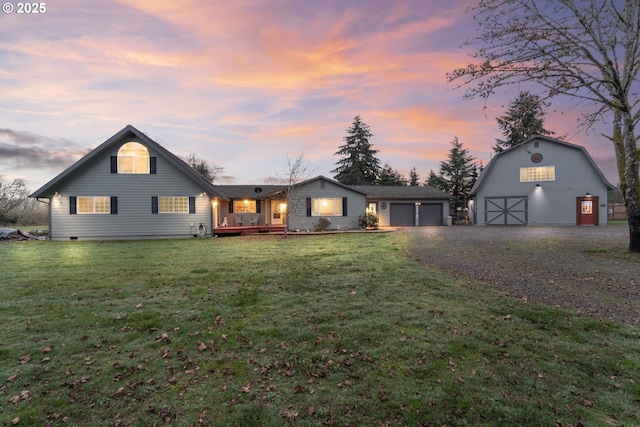 view of front of house featuring a lawn and an outdoor structure