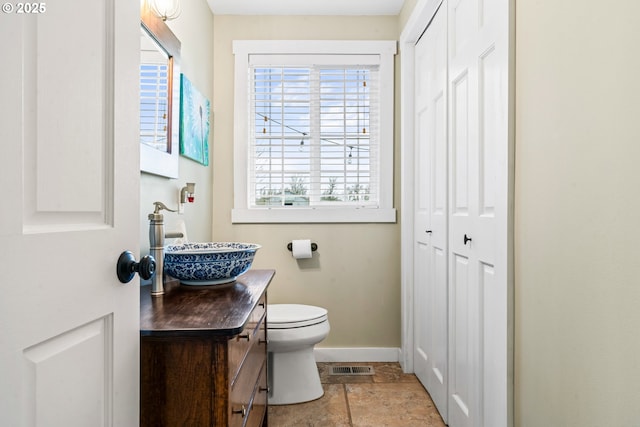 bathroom with toilet and vanity