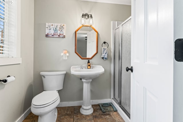 bathroom featuring toilet and walk in shower