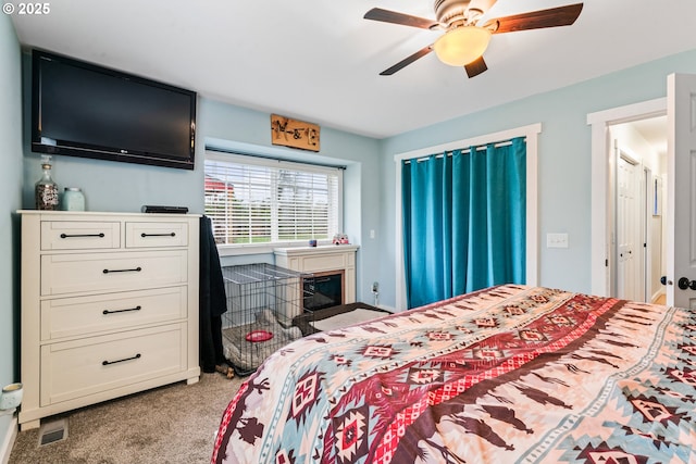 bedroom with ceiling fan and light carpet