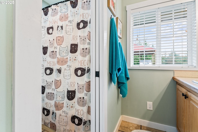 bathroom featuring vanity, a shower with shower curtain, and tile patterned flooring