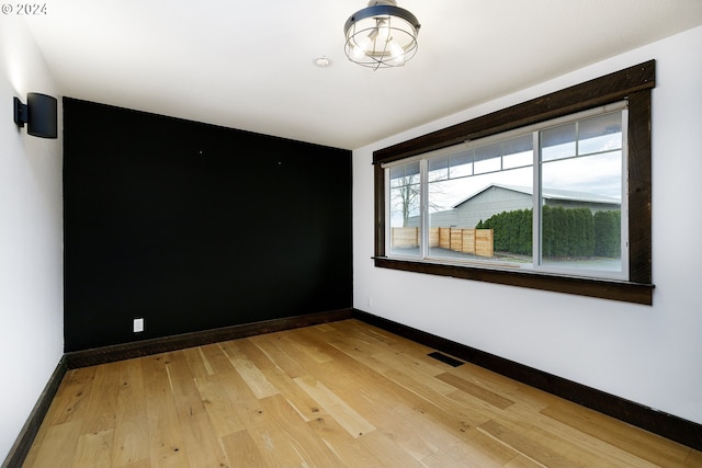 unfurnished room with wood-type flooring