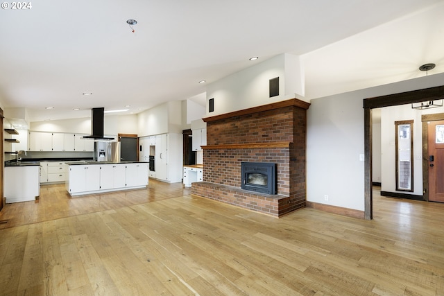 unfurnished living room with sink and light hardwood / wood-style flooring