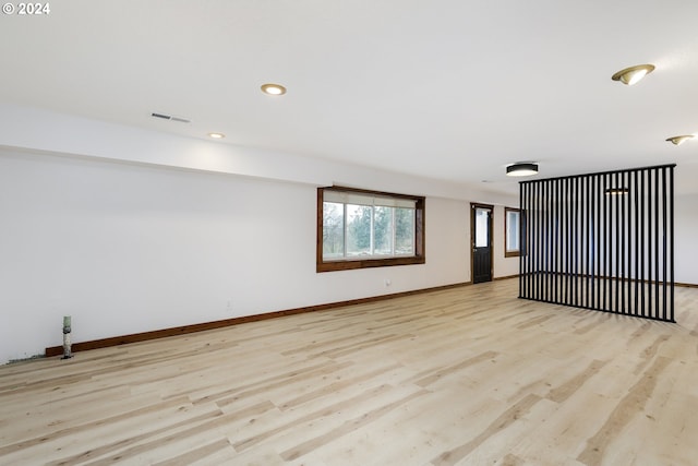 unfurnished room with light wood-type flooring