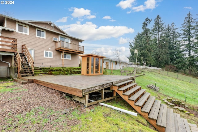 wooden deck featuring a lawn and an AC wall unit