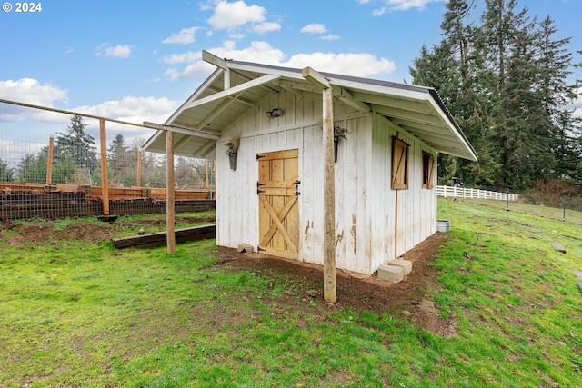 view of outbuilding featuring a lawn