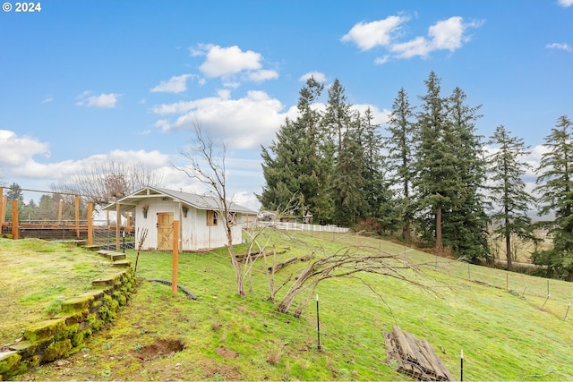 view of yard with a rural view and an outbuilding