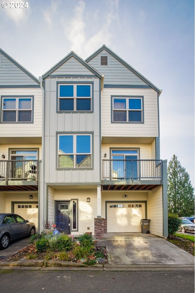 511 NE 84th Cir, Vancouver, WA 98665 - multi unit property with an attached garage, board and batten siding, concrete driveway, and a balcony