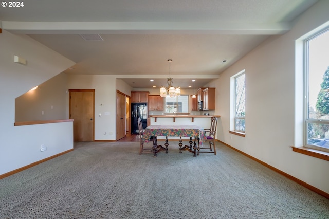 interior space with a notable chandelier and light carpet