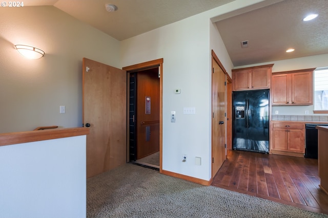 kitchen with black appliances, dark hardwood / wood-style flooring, and lofted ceiling