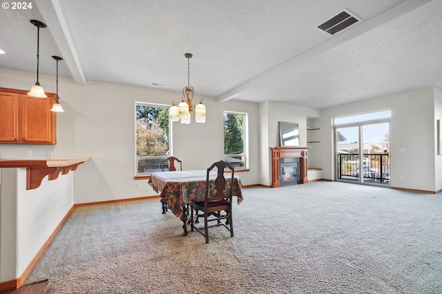 carpeted dining room with beamed ceiling, a textured ceiling, and a chandelier