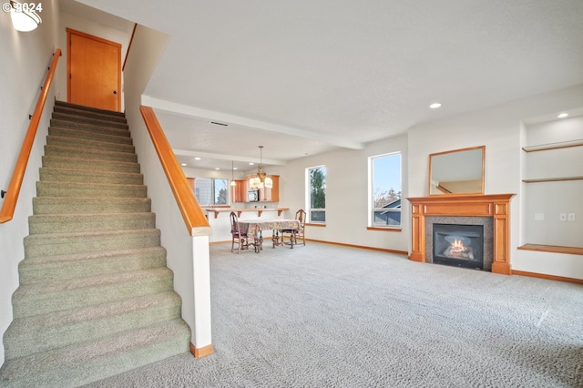 stairs featuring carpet floors and an inviting chandelier