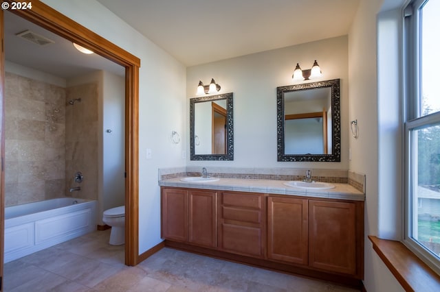 511 NE 84th Cir, Vancouver, WA 98665 - bathroom with toilet, double vanity, bathing tub / shower combination, baseboards, and tile patterned floors