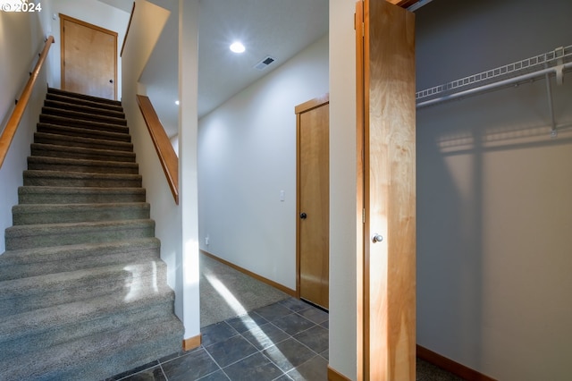 stairway featuring tile patterned flooring