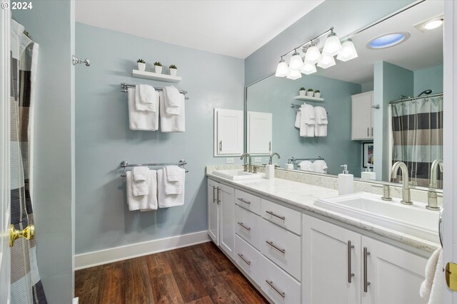 bathroom with vanity and wood-type flooring