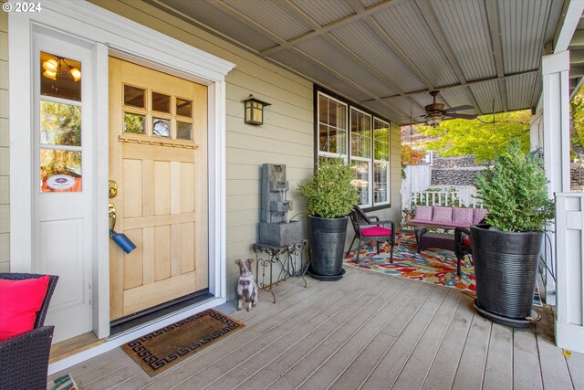 deck with covered porch and ceiling fan