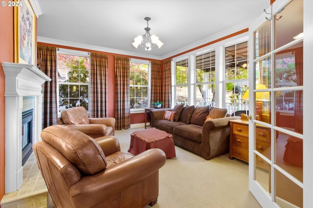 carpeted living room featuring ornamental molding, a chandelier, a tiled fireplace, and plenty of natural light