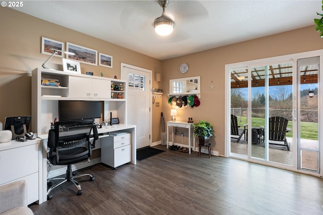 home office with ceiling fan and dark hardwood / wood-style flooring