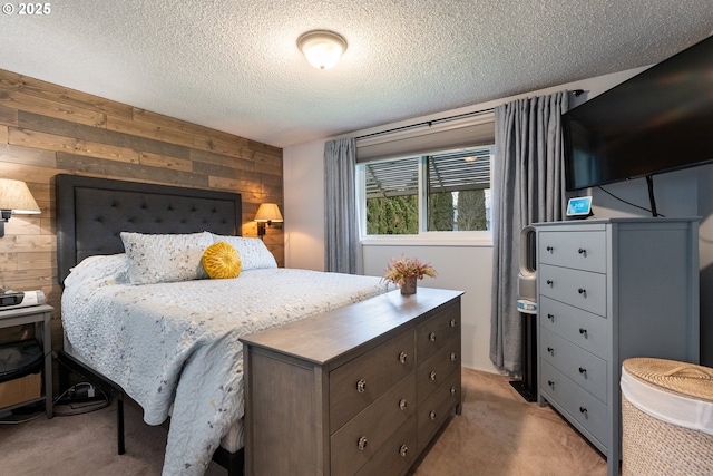 carpeted bedroom featuring a textured ceiling and wood walls