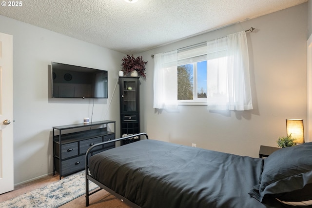 carpeted bedroom featuring a textured ceiling