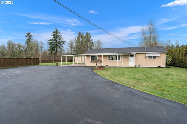 ranch-style home with a front lawn and a carport