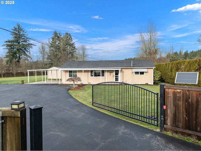 ranch-style home featuring a carport and a front lawn