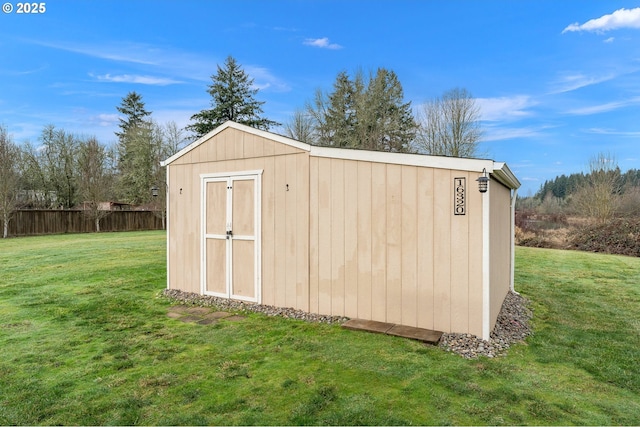 view of outbuilding with a yard