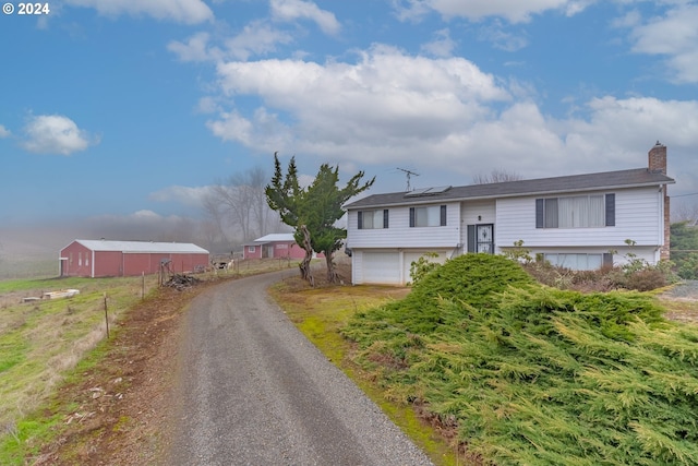 view of front of house featuring a garage and solar panels