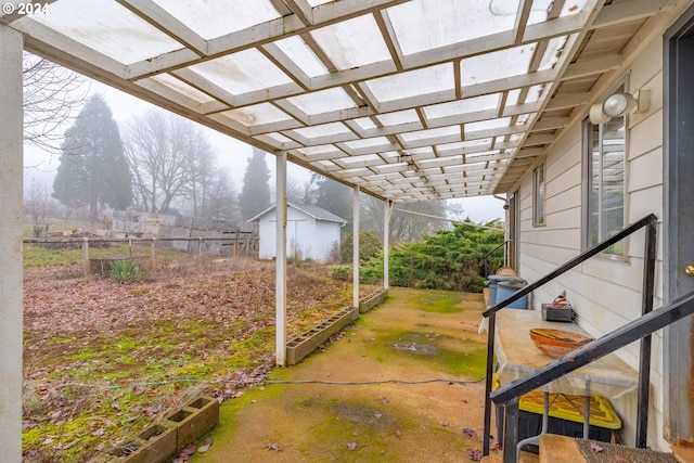 view of patio featuring a storage shed