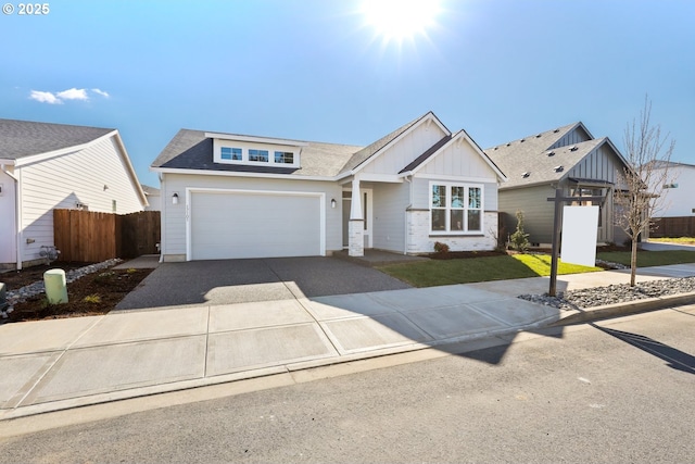 view of front facade with board and batten siding, a front lawn, fence, concrete driveway, and roof with shingles