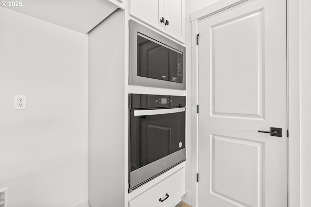 room details with stainless steel microwave and wall oven