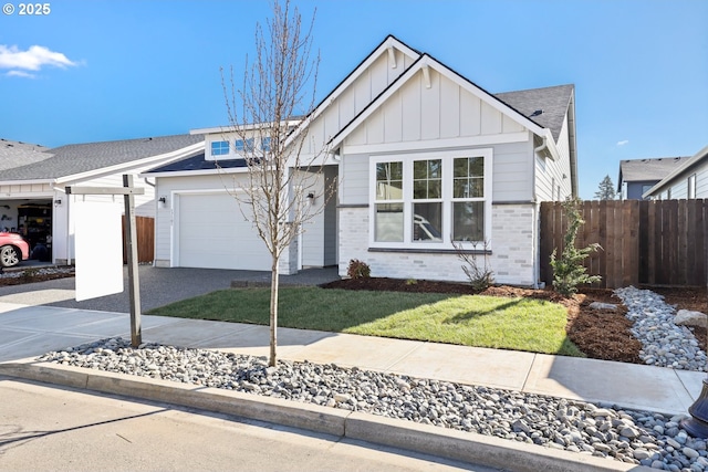 view of front facade with brick siding, board and batten siding, fence, a garage, and driveway