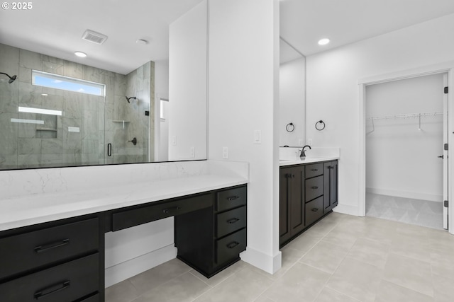 bathroom with visible vents, a shower stall, a walk in closet, recessed lighting, and vanity