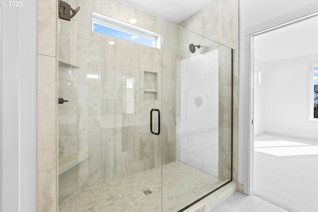 full bathroom with tile patterned floors and a stall shower