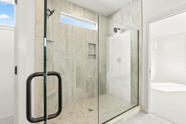 full bathroom featuring tile patterned floors and a shower stall