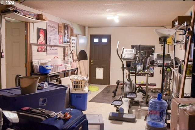 exercise room featuring a textured ceiling