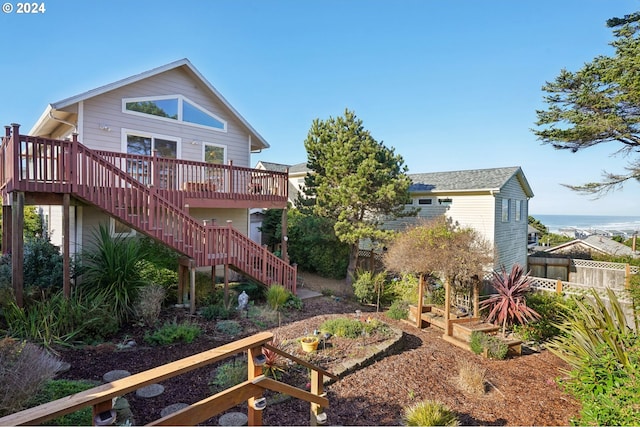 rear view of property featuring a wooden deck