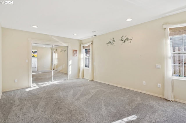 unfurnished bedroom featuring carpet floors and a closet